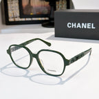 Chanel eyeglasses with green frames, clear lenses, and ribbed temple detail.