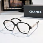 Chanel eyeglasses with black frames, clear lenses, and Chanel logo on temple.