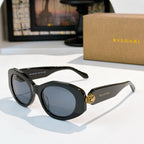 Black Bvlgari round-frame sunglasses with gold logo temple detail and blue-tinted lenses