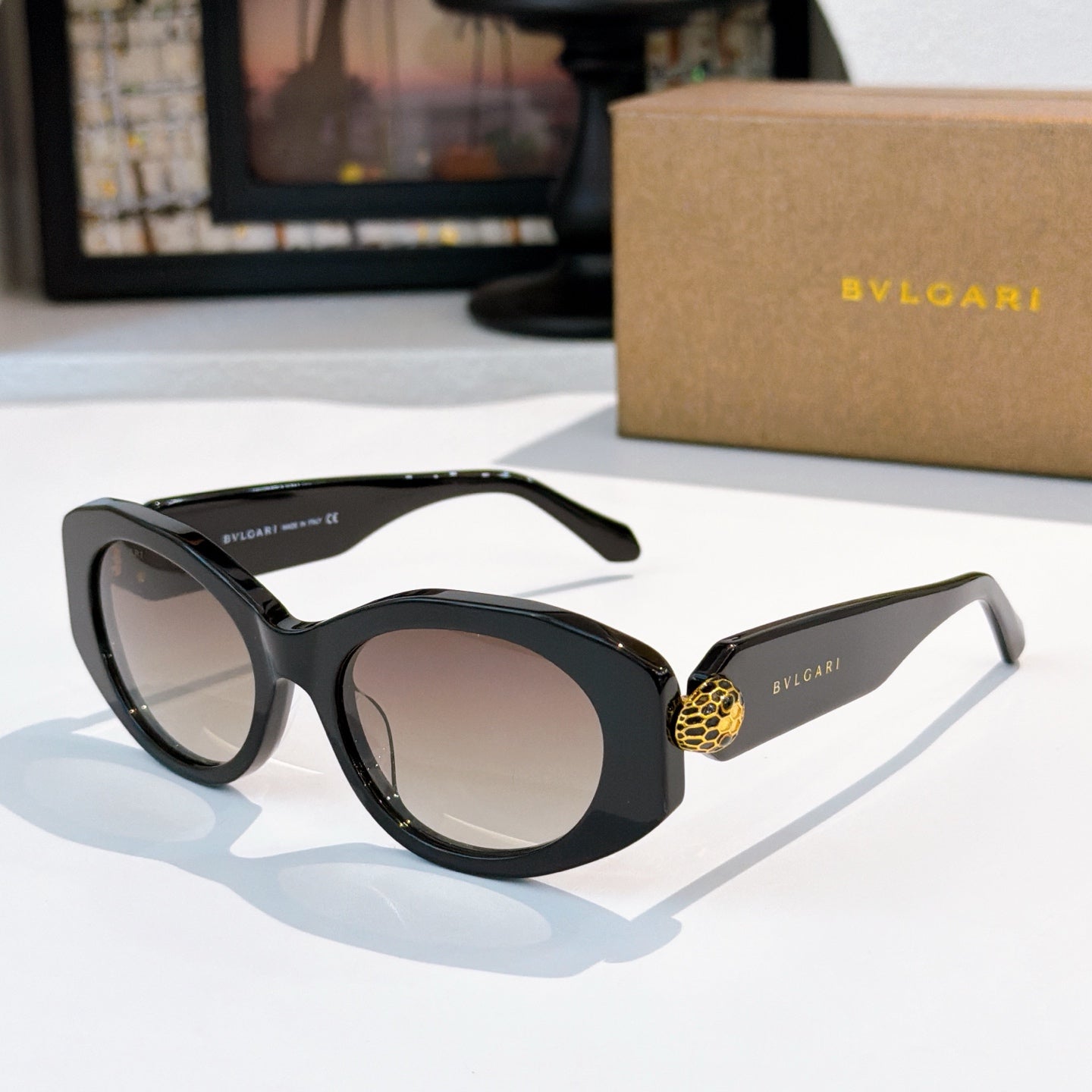 Dark brown Bvlgari cat-eye sunglasses with gold logo detail and neutral tinted lenses