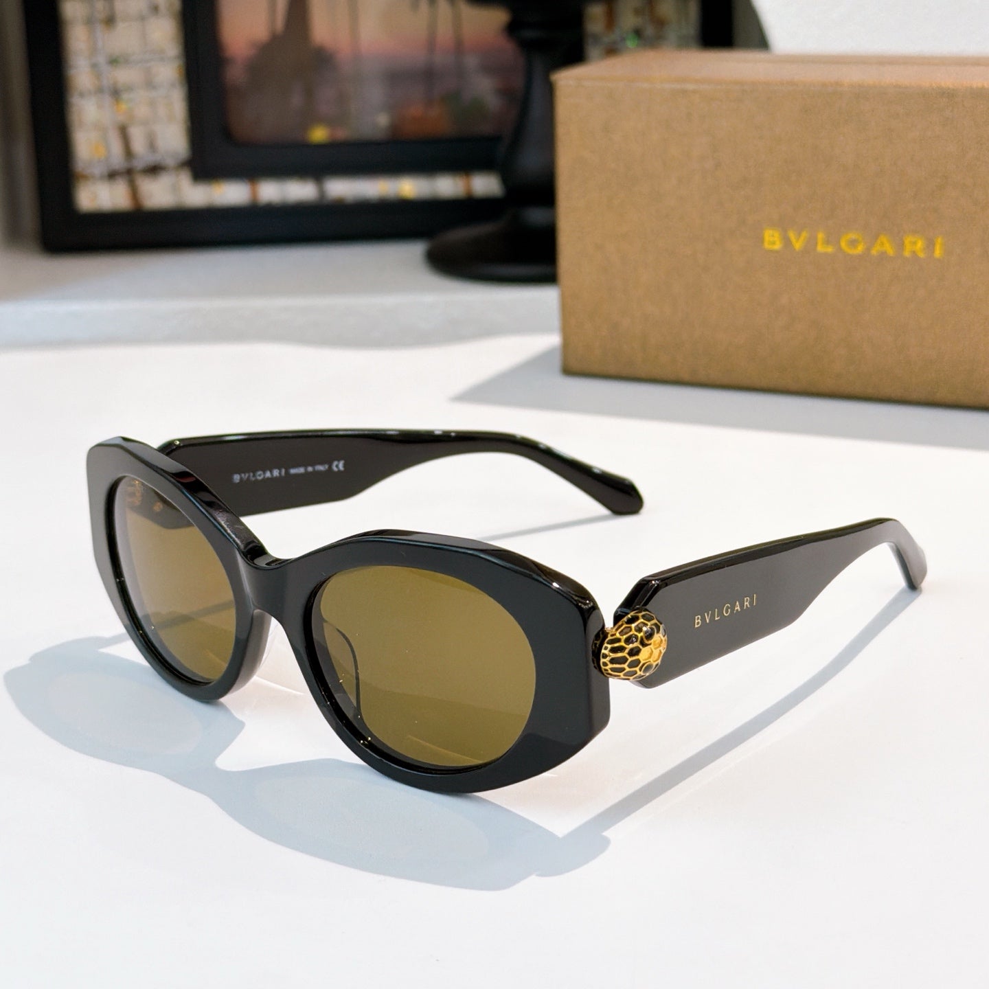 Black Bvlgari sunglasses with gold logo temple detail and yellow tinted lenses