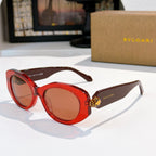 Red Bvlgari round-frame sunglasses with gold logo detail on the temple and tinted lenses