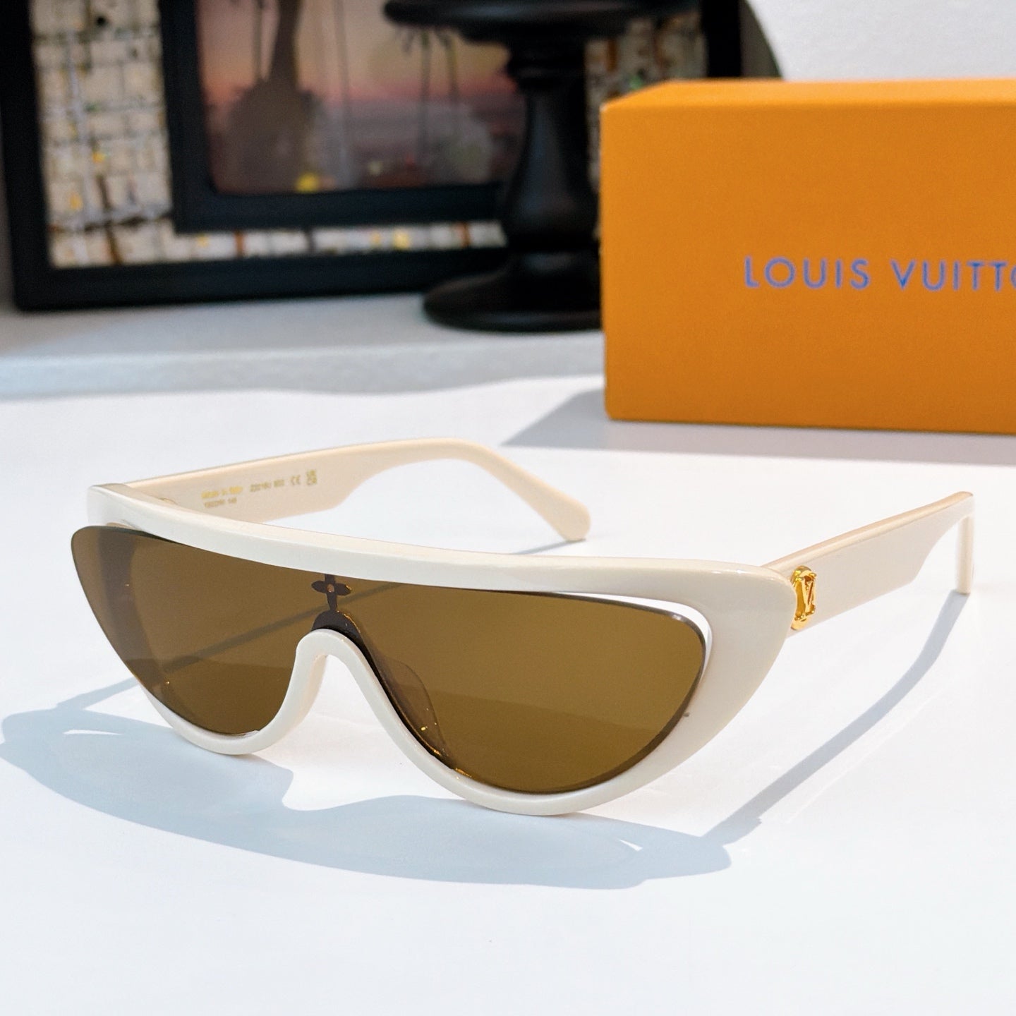 Louis Vuitton sunglasses with white frame and dark brown tinted lenses