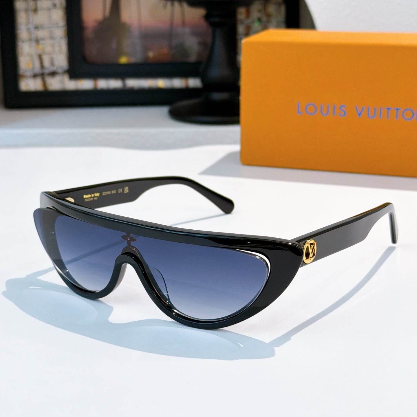 Louis Vuitton sunglasses with black frame and blue tinted lenses