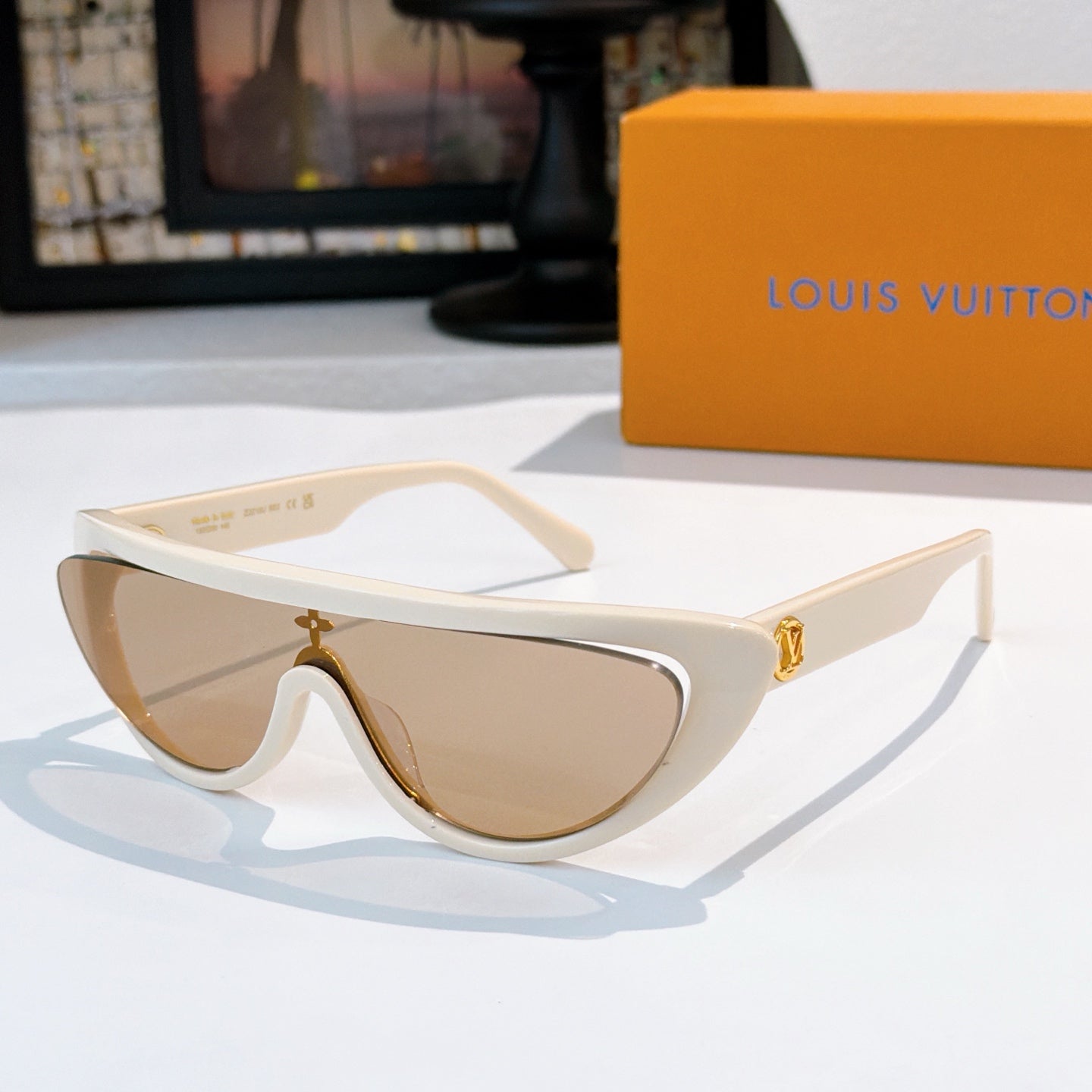 Louis Vuitton sunglasses with white frame and tan tinted lenses