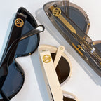 Louis Vuitton sunglasses close-up with gold logo hardware and tinted lenses