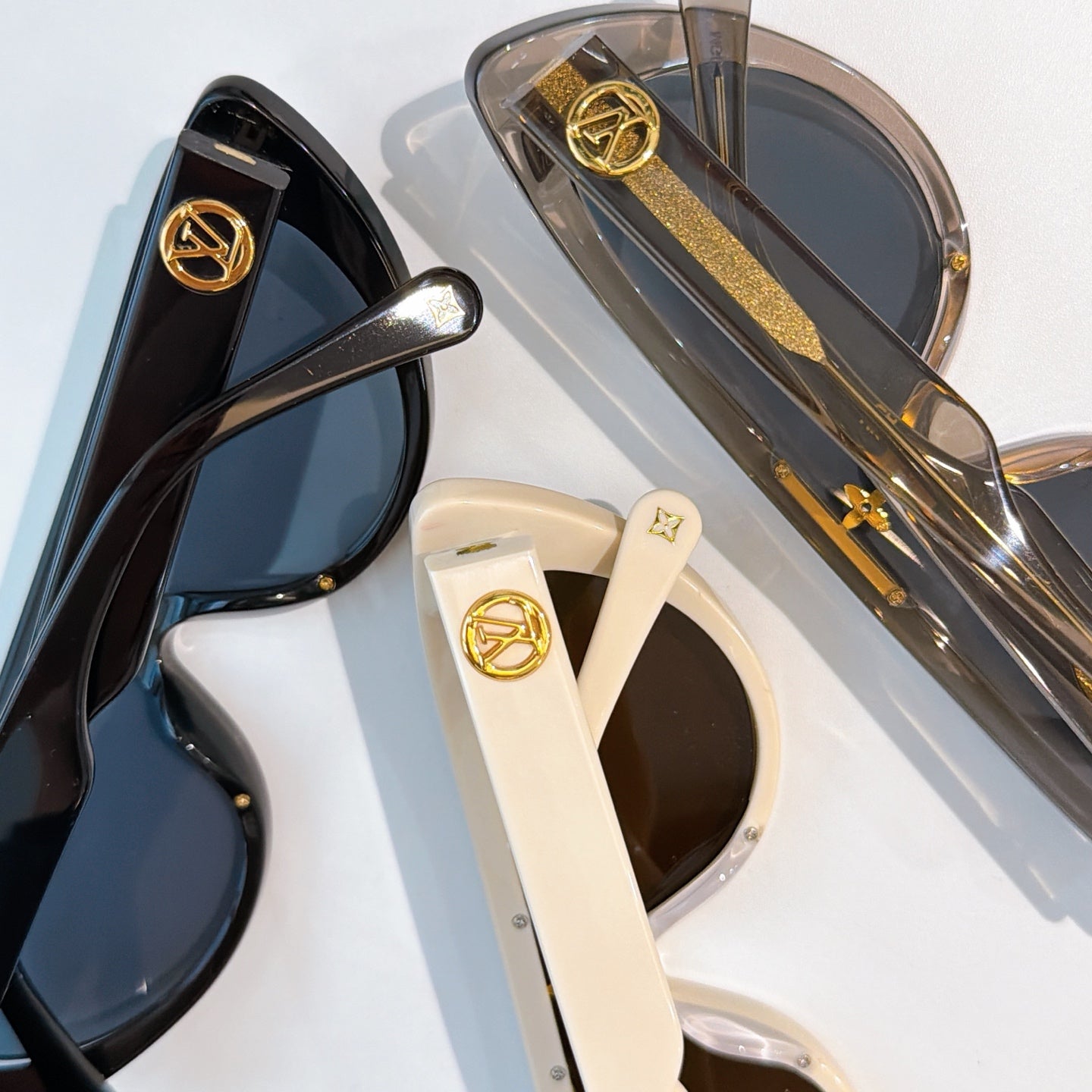 Louis Vuitton sunglasses close-up with gold logo hardware and tinted lenses
