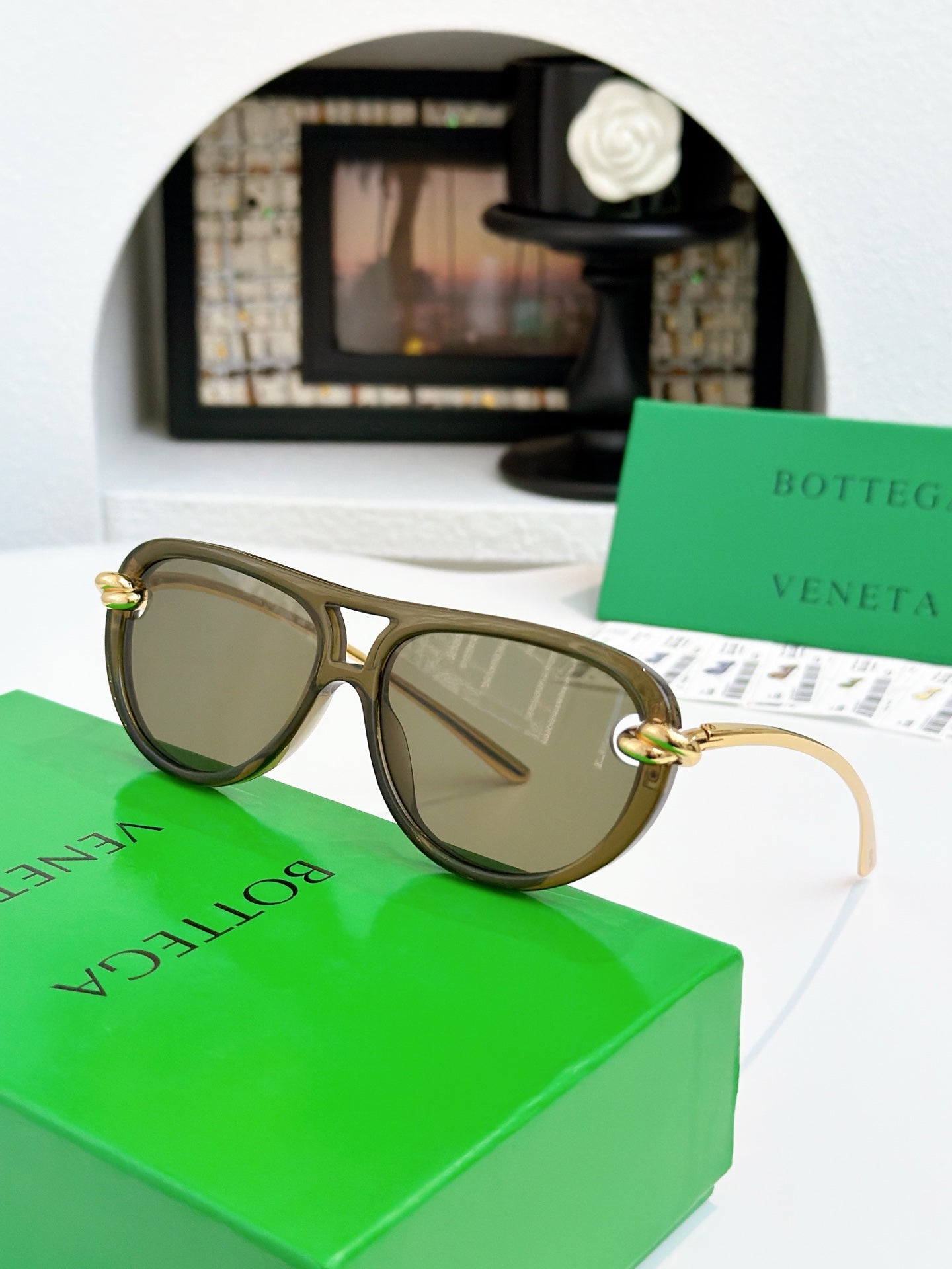 Sunglasses with tortoise-pattern frame and gold-tone accents, brown-tinted lenses.