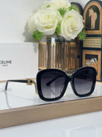 Celine black oversized sunglasses with dark tinted lenses and gold-toned hinge details