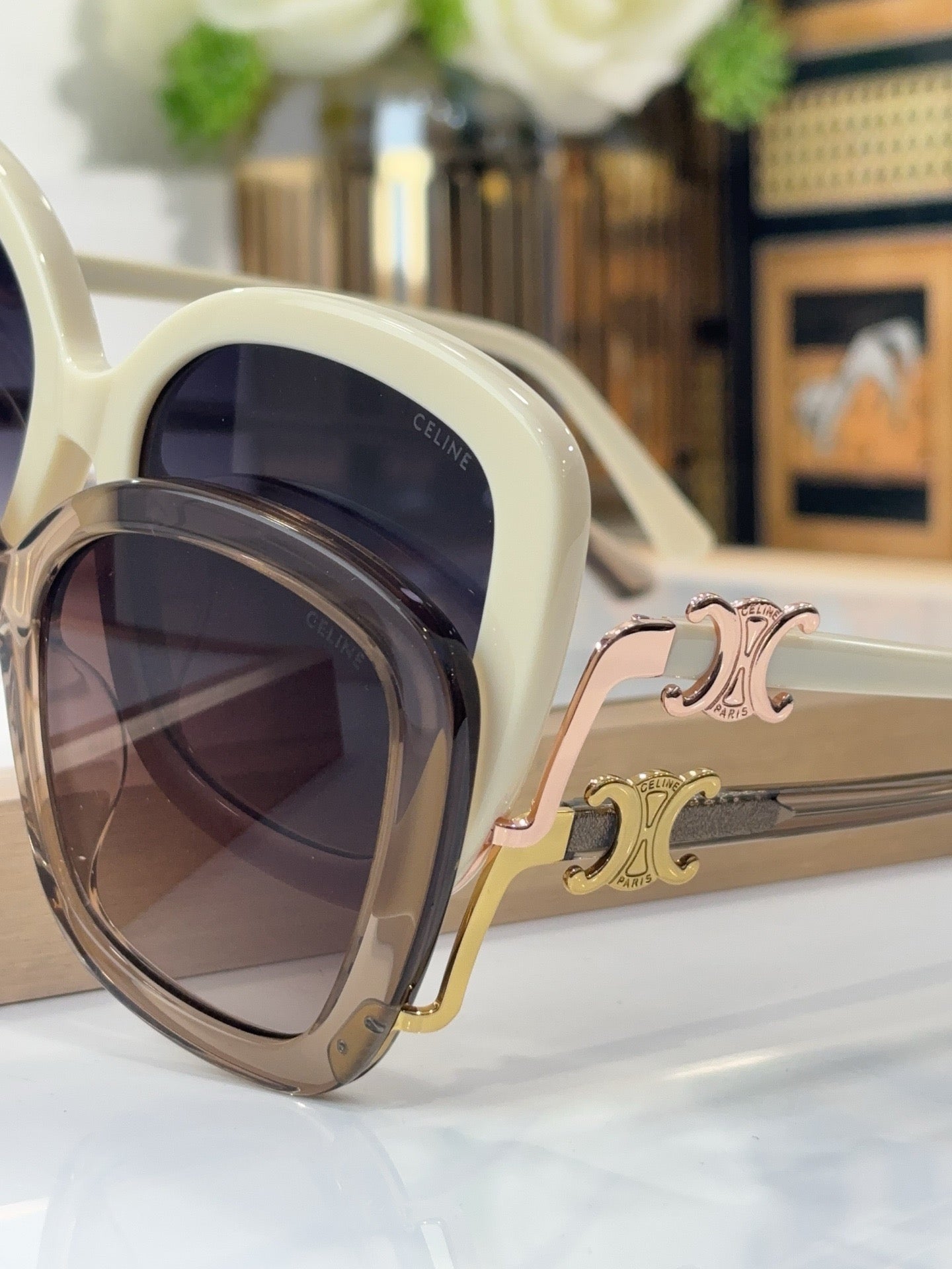 Celine cream sunglasses with dark lenses and gold-toned decorative hinge detail