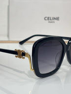 Celine black oval sunglasses with dark tinted lenses and gold-toned hinge accents
