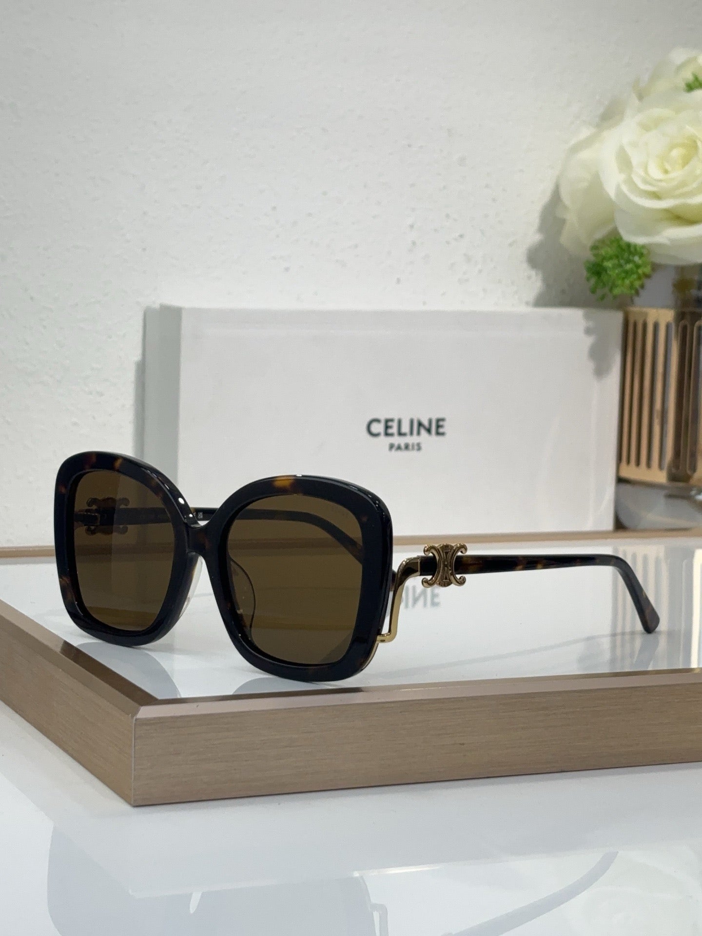 Celine black square sunglasses with dark tinted lenses and gold-toned hinge details