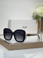 Celine black oversized sunglasses with dark tinted lenses and gold-toned hinge accents