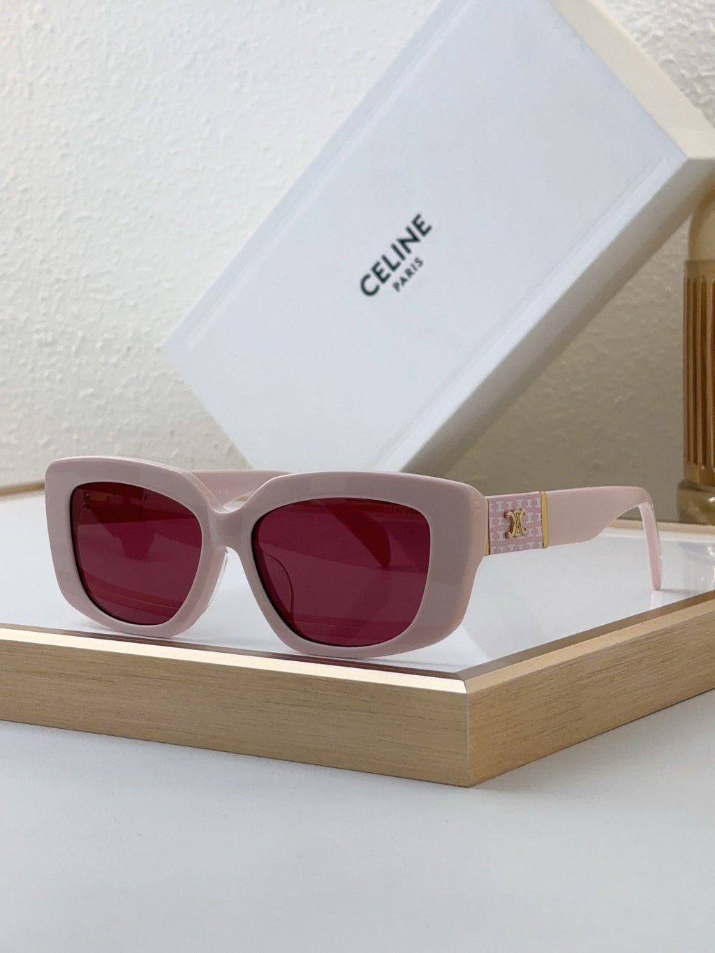 Celine sunglasses with light pink frame and red tinted lenses
