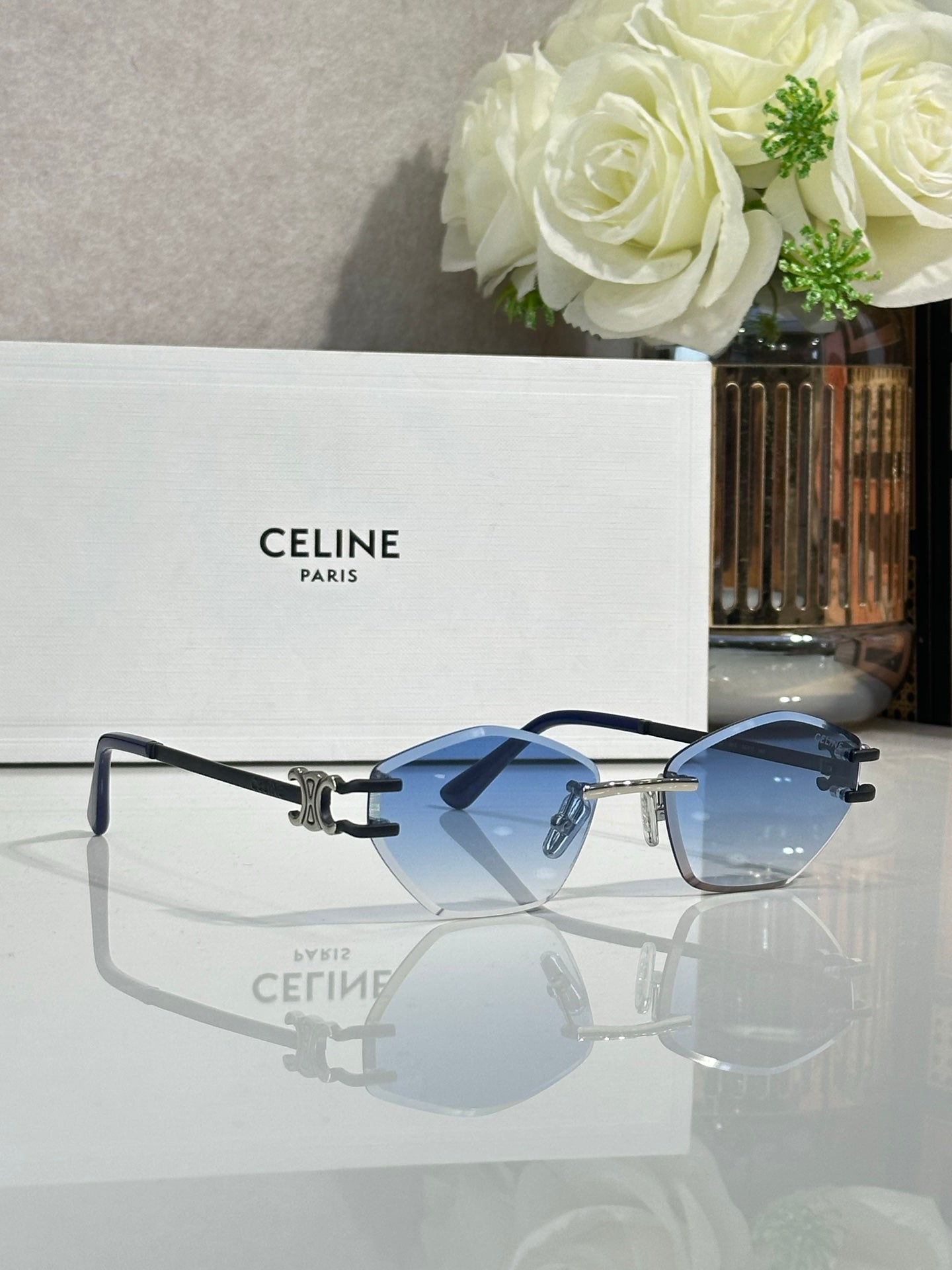 Metal-framed sunglasses with blue lenses and dark blue temple arms