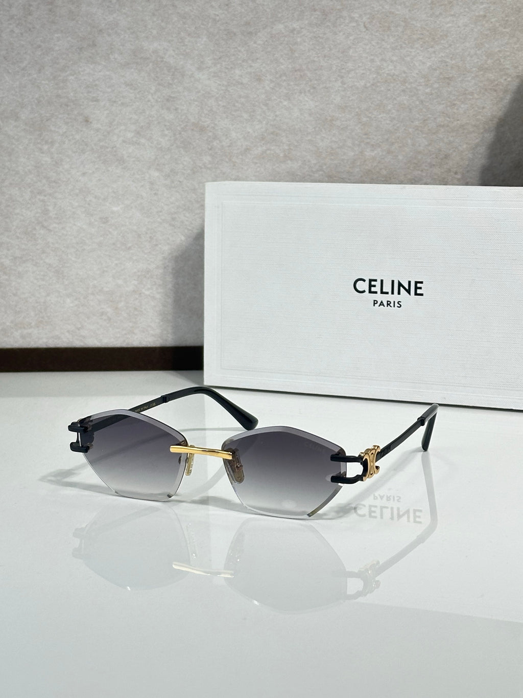 Metal-framed sunglasses with dark gray lenses and black temple tips