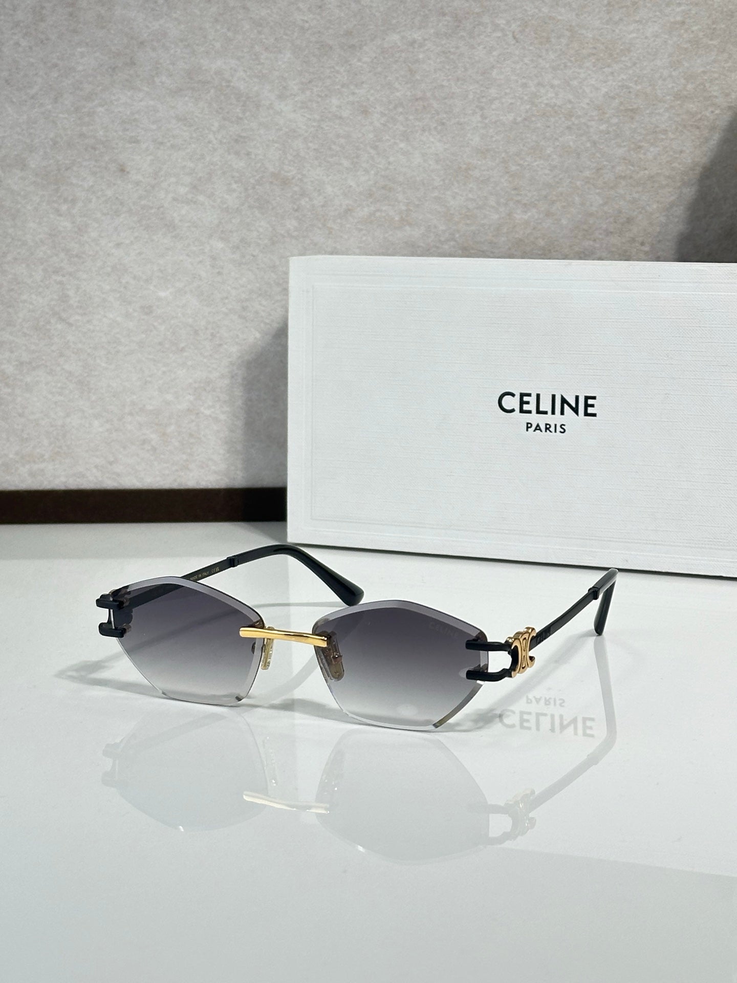 Metal-framed sunglasses with dark gray lenses and black temple tips