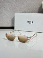 Metal-framed sunglasses with light tan lenses and gold-tone temple arms