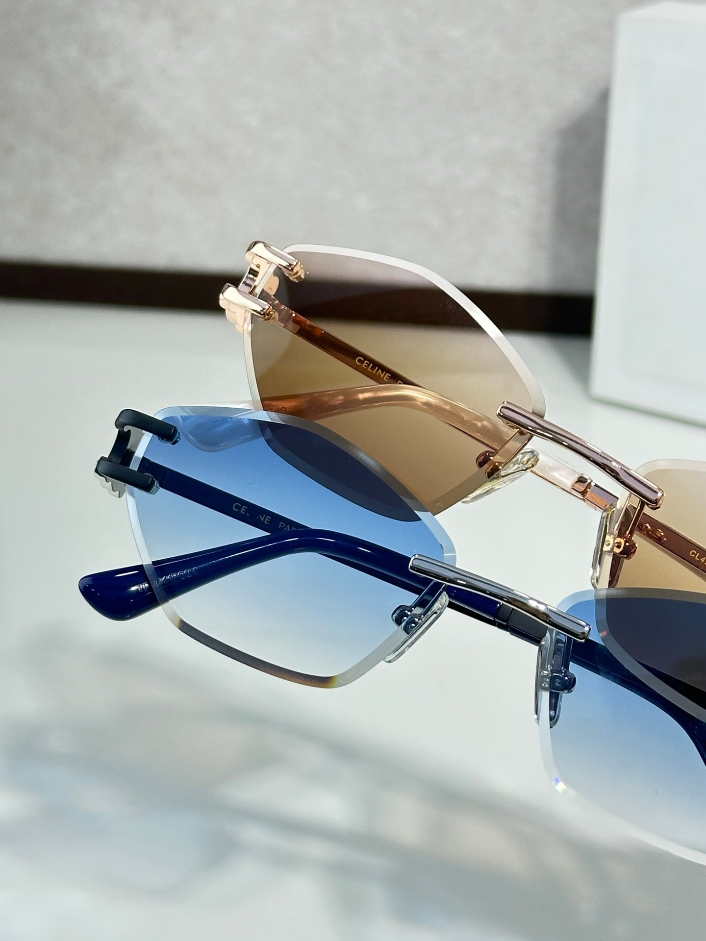Metal-framed sunglasses with blue lenses and clear top bar