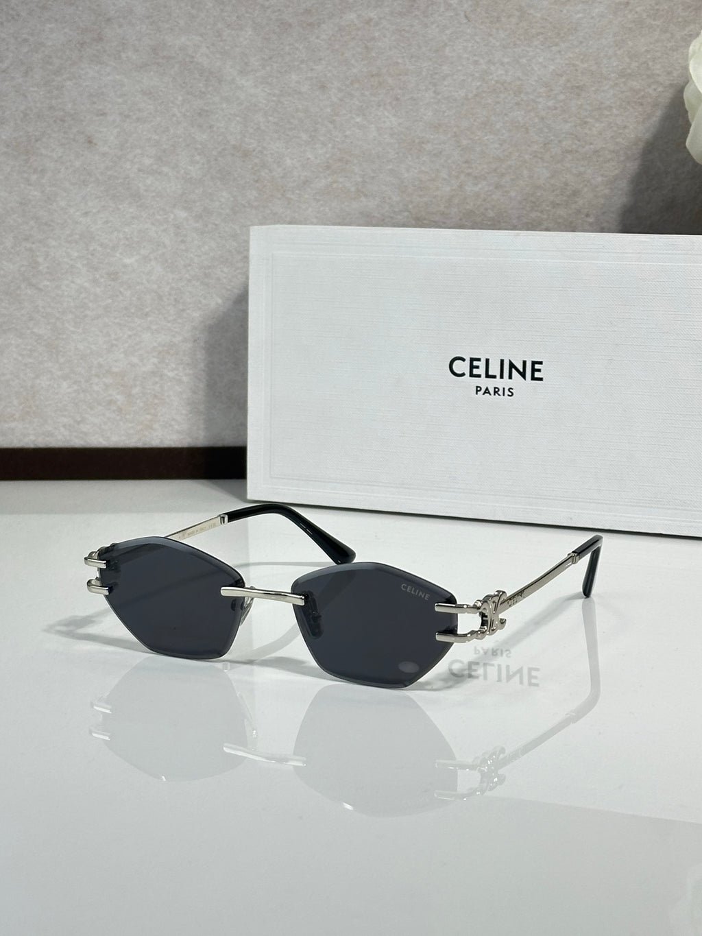 Metal-framed sunglasses with dark lenses and gold-tone bridge hardware