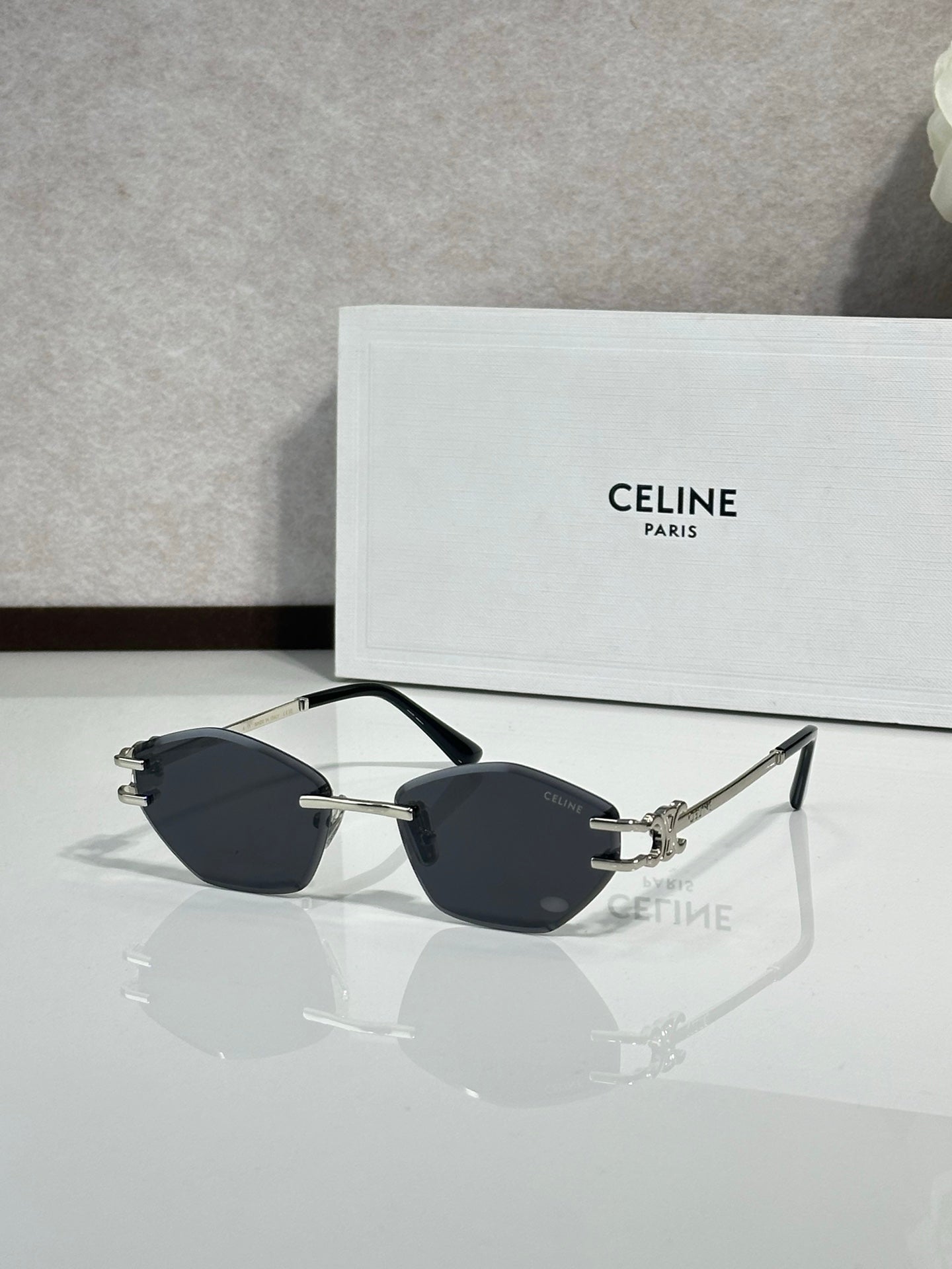 Metal-framed sunglasses with dark lenses and gold-tone bridge hardware