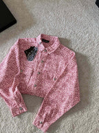 Pink long-sleeve button-up shirt with all-over pattern and front button closures