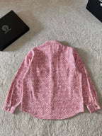 Pink long-sleeve button-up shirt with all-over patterned print and button front