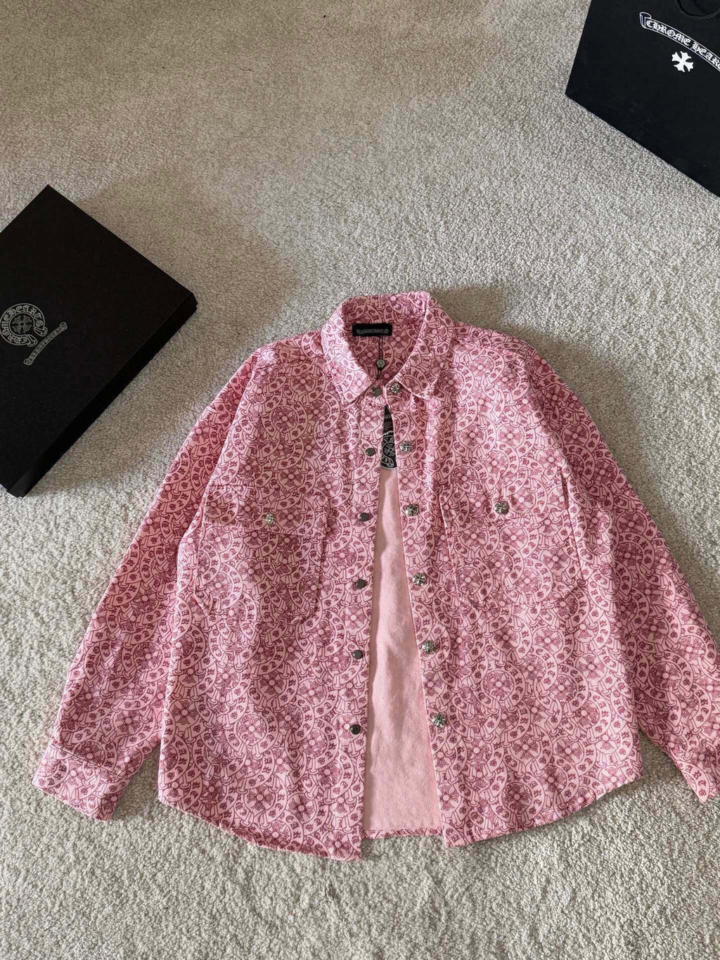 Pink long-sleeve button-up shirt with pointed collar and patterned fabric