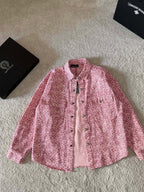 Pink long-sleeve button-up shirt with pointed collar and patterned fabric