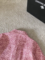 Pink patterned long-sleeve shirt close-up of upper back and collar area