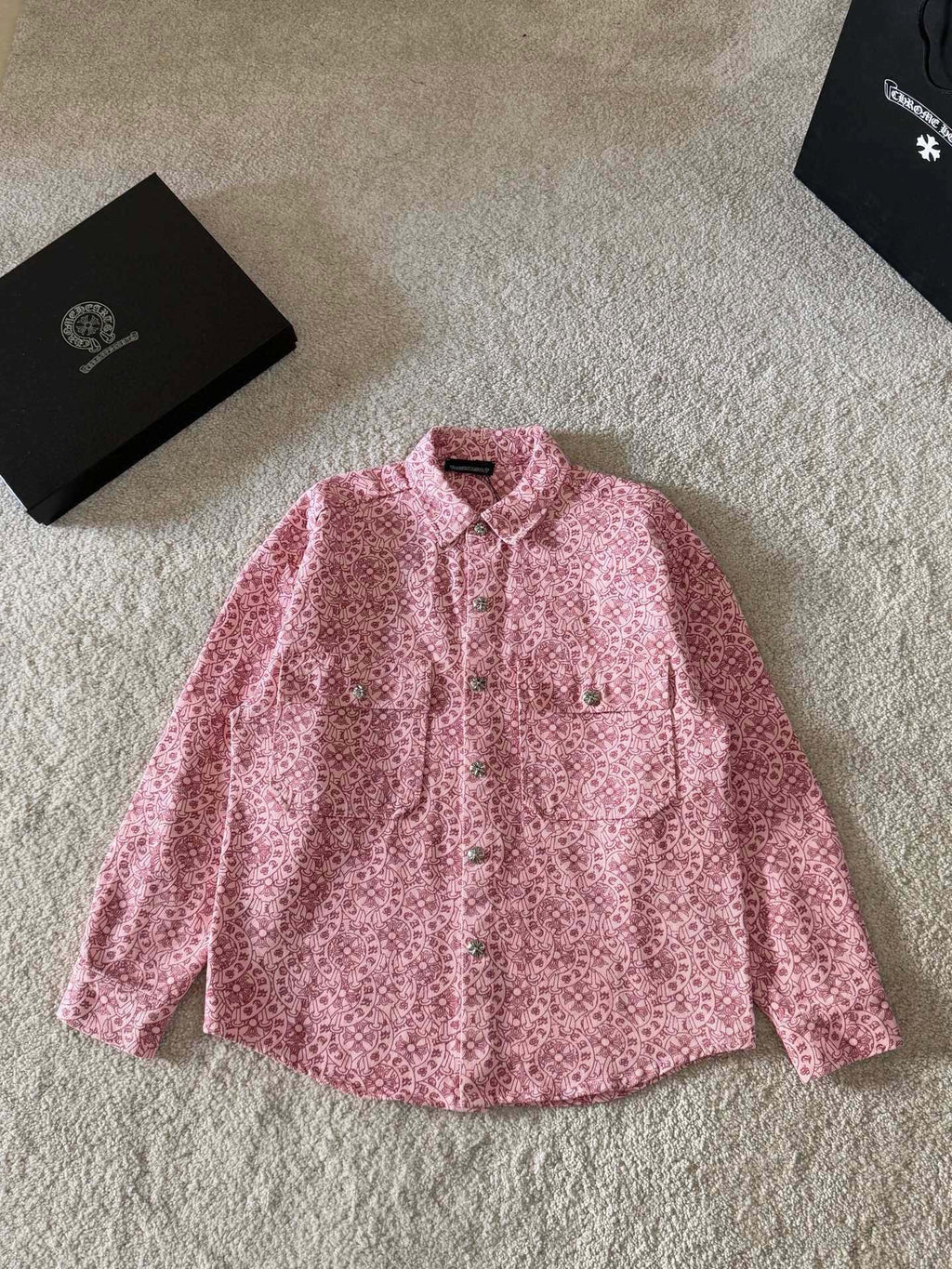 Pink long-sleeve button-up shirt with small patterned print and pointed collar