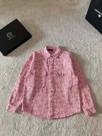 Pink long-sleeve button-up shirt with small patterned print and pointed collar