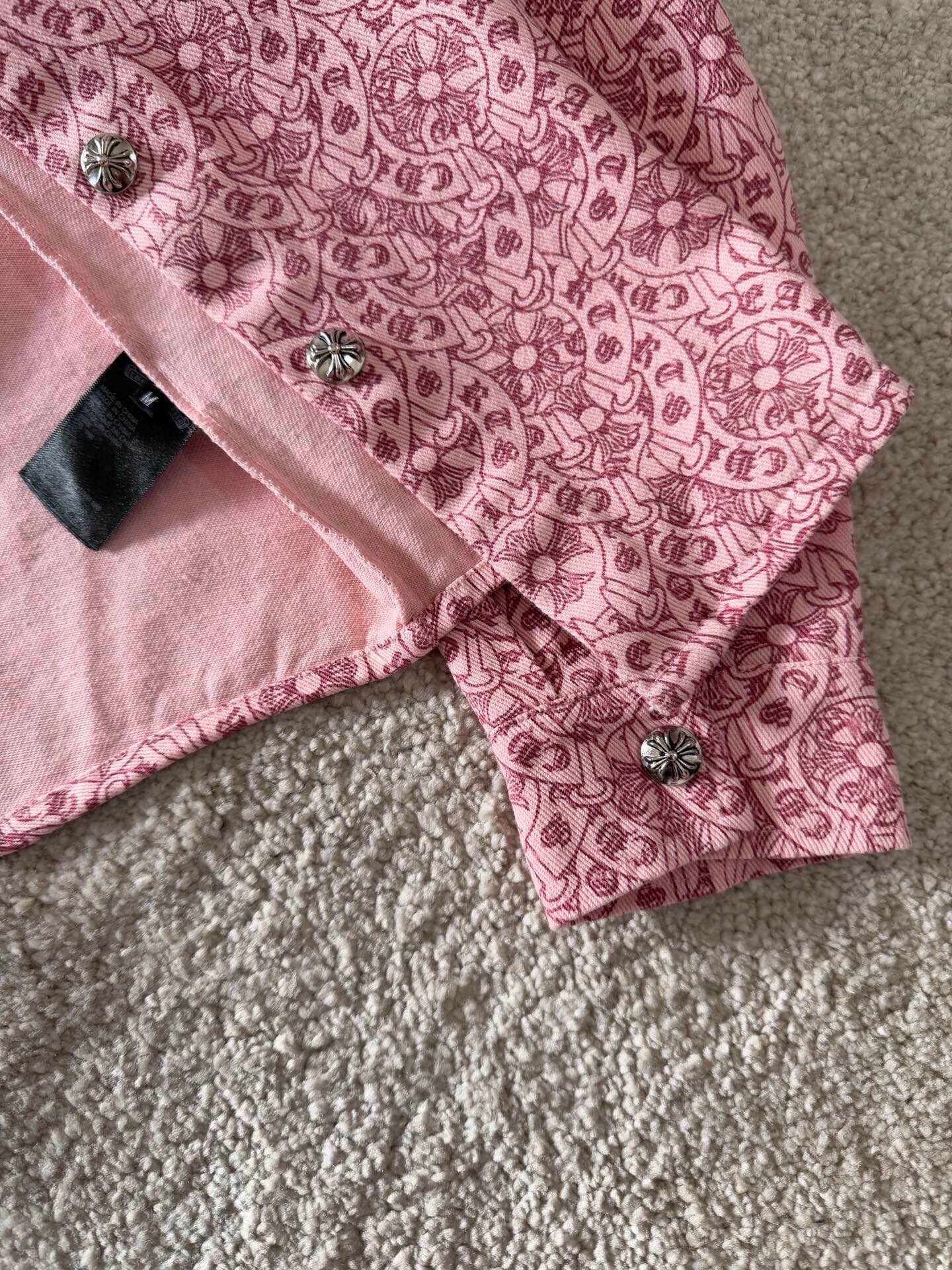 Pink patterned long-sleeve shirt sleeve cuff with button detail and black tag
