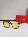 Prada sunglasses with black frame and yellow-tinted lenses