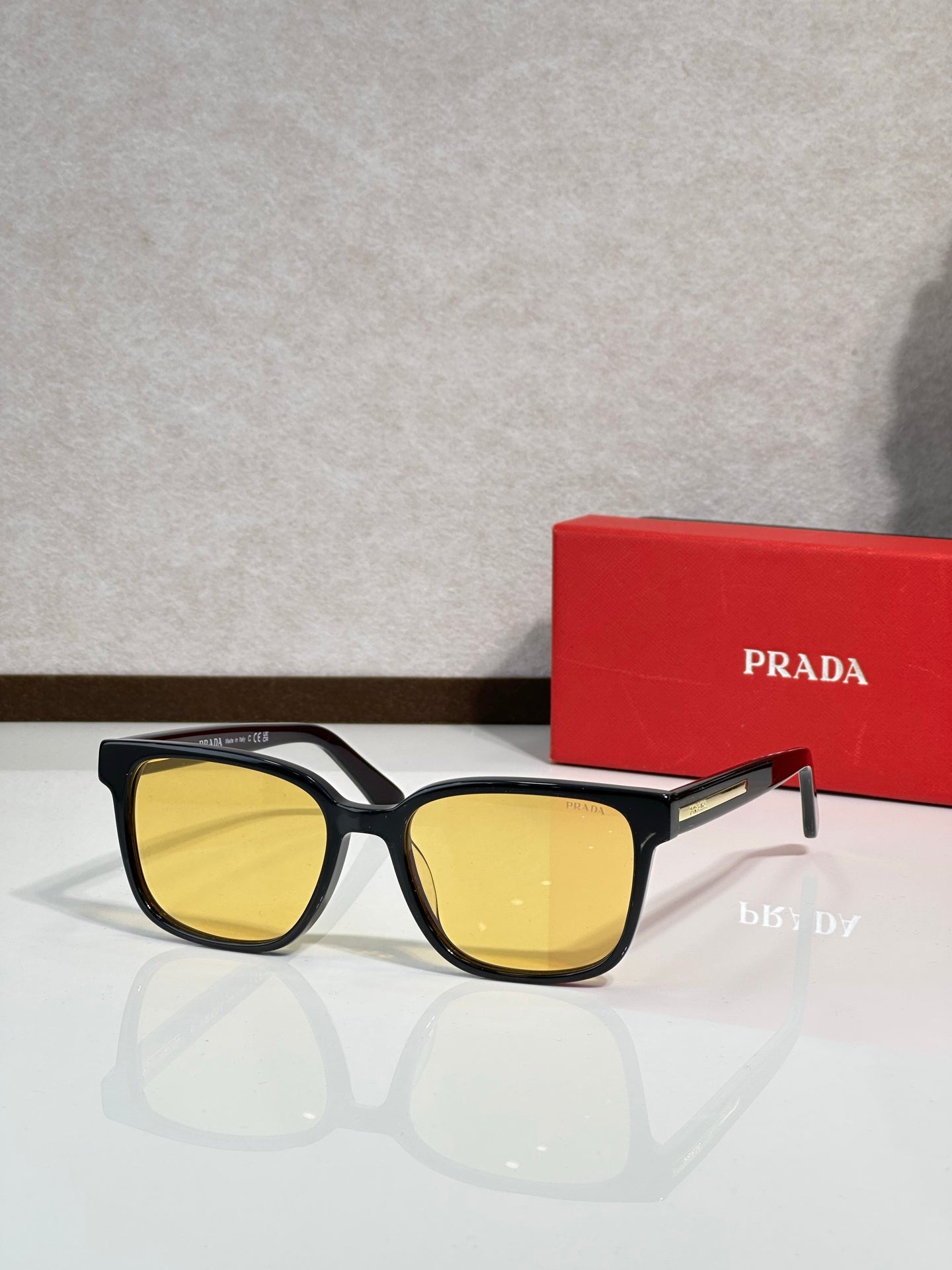 Prada sunglasses with black frame and yellow-tinted lenses