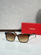 Prada sunglasses with tortoiseshell frame and amber-tinted lenses