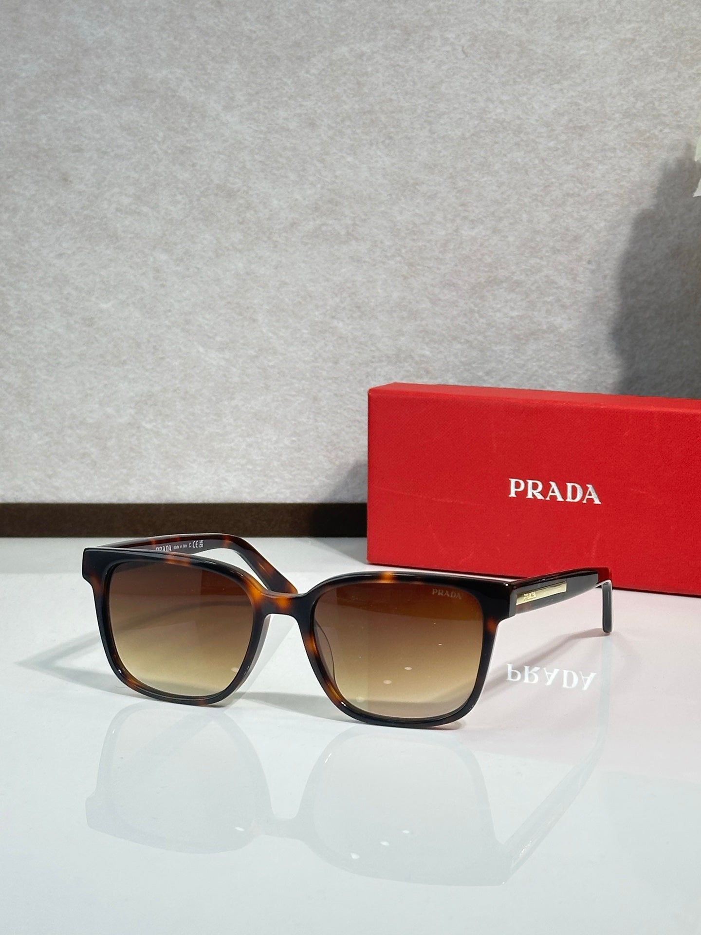Prada sunglasses with tortoiseshell frame and amber-tinted lenses