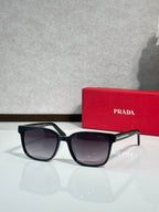 Prada sunglasses with black frame and dark tinted lenses