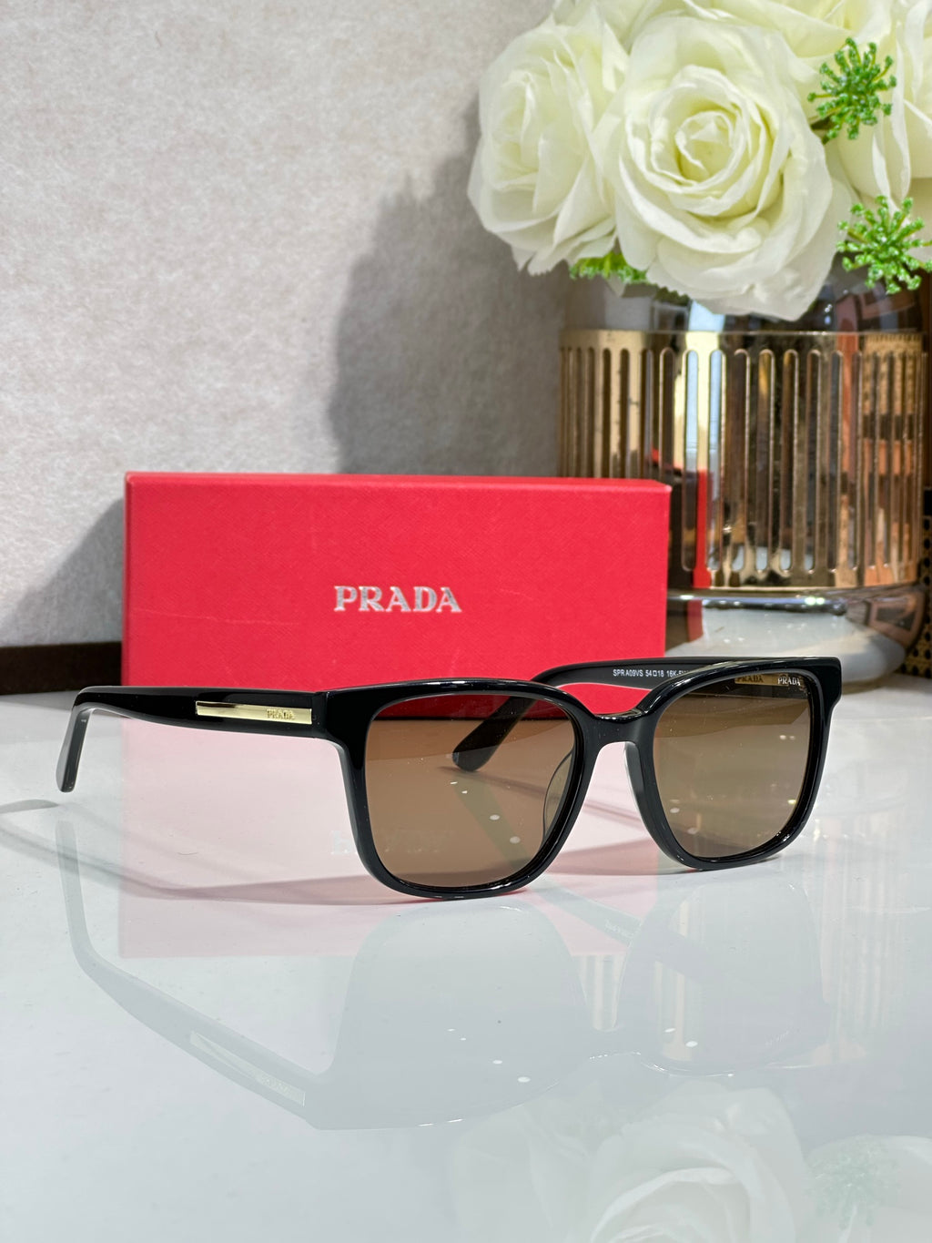 Prada sunglasses with black frame and brown gradient lenses