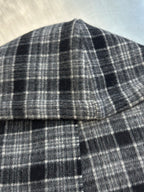 Plaid poncho neckline with stitched seam and small button detail
