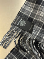 Balenciaga label on plaid poncho with fringe trim