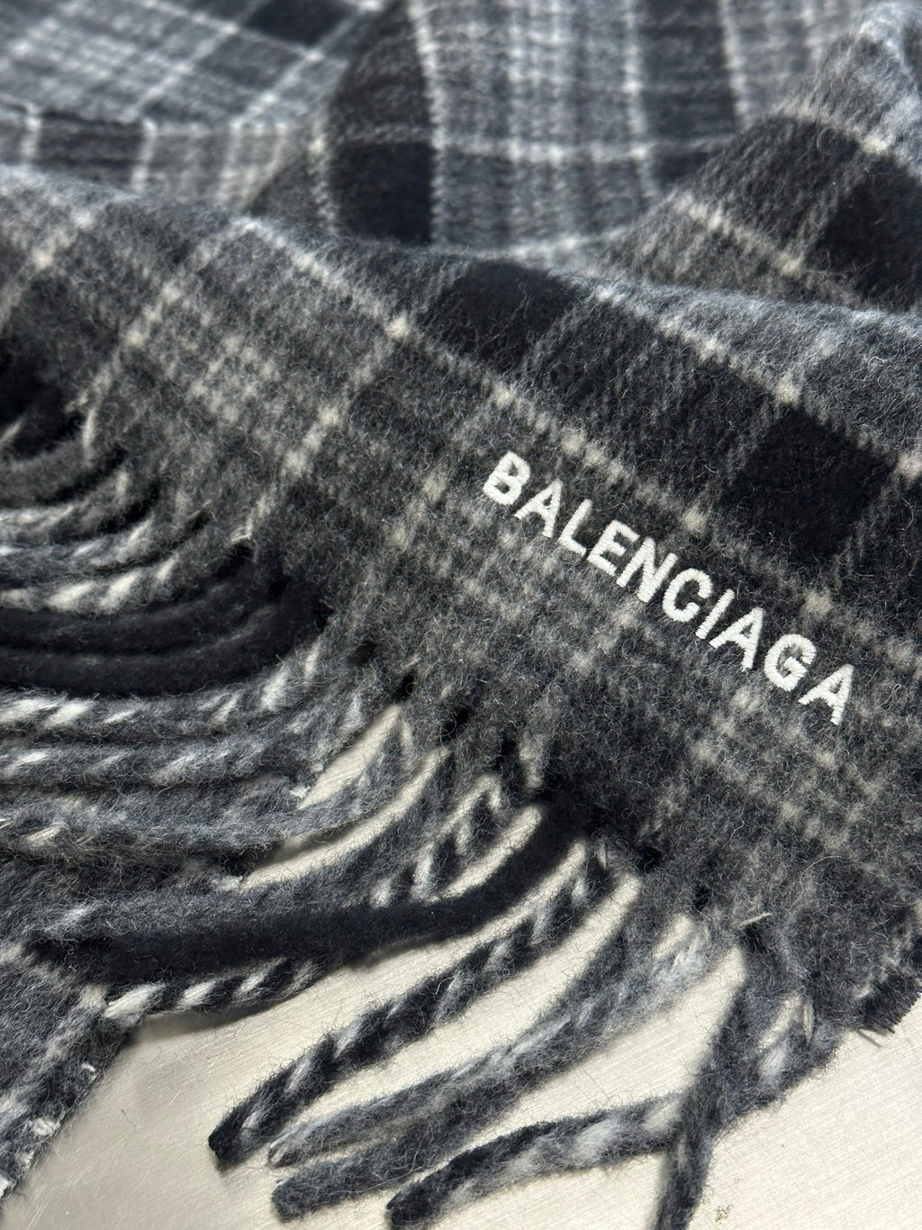 Balenciaga logo printed on plaid poncho fabric with fringe