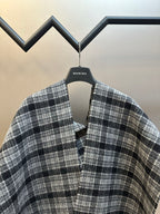 Balenciaga plaid poncho with V neckline and buttoned placket, fringe edge
