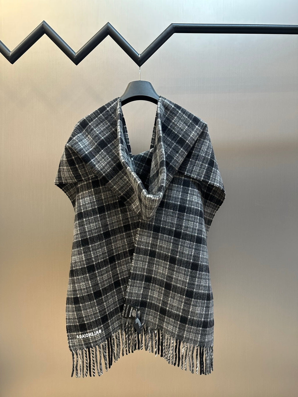Balenciaga plaid poncho draped on hanger, open front with fringe trim