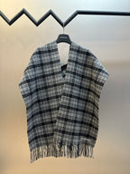 Balenciaga plaid poncho with V neckline, open front, and fringe hem