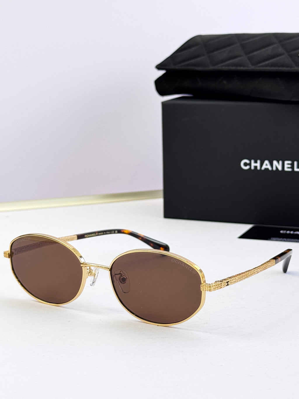 Round sunglasses with gold frame and brown tinted lenses