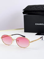 Round sunglasses with gold frame and pink tinted lenses