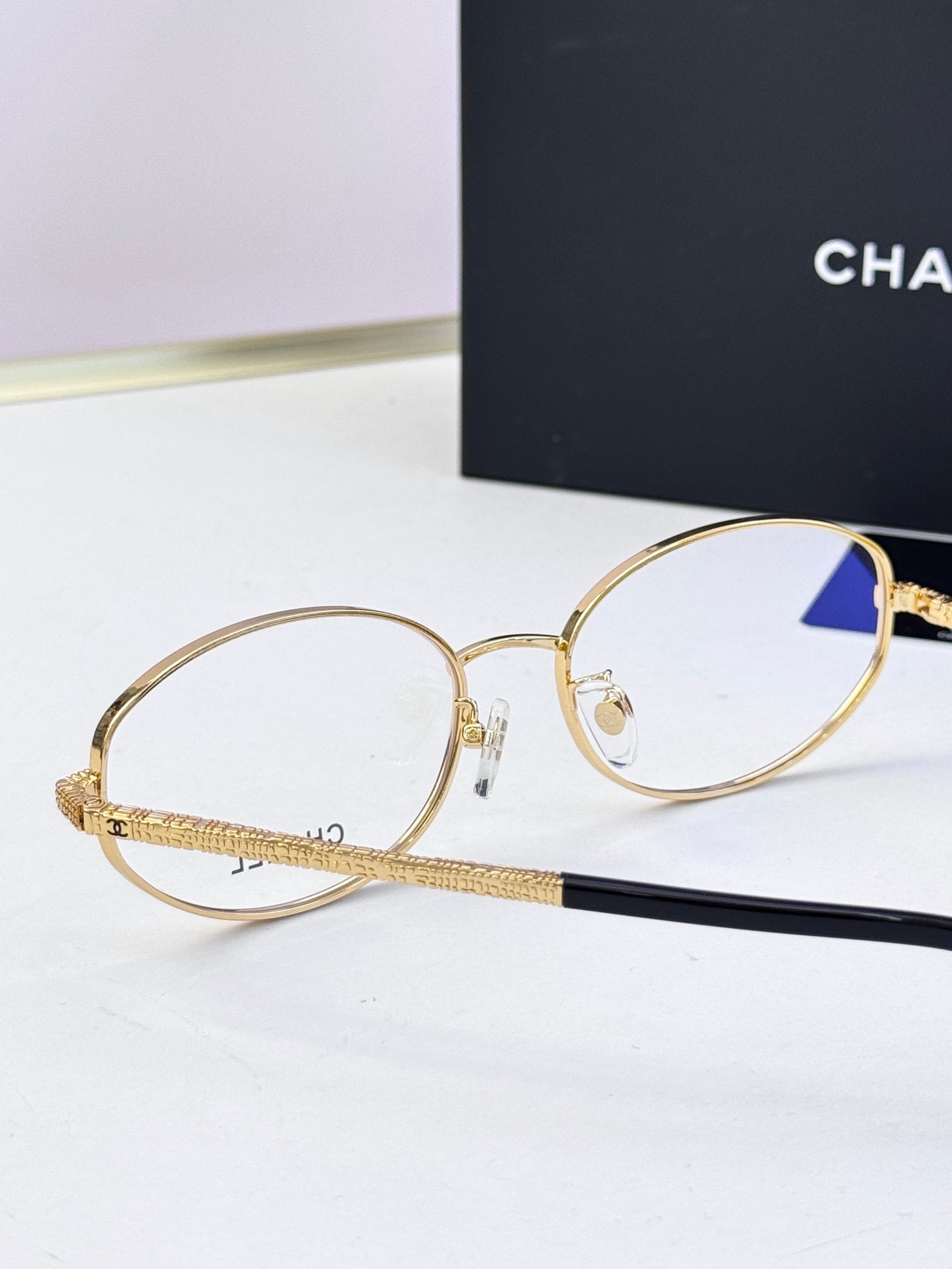 Chanel eyeglasses with gold round frames and clear lenses