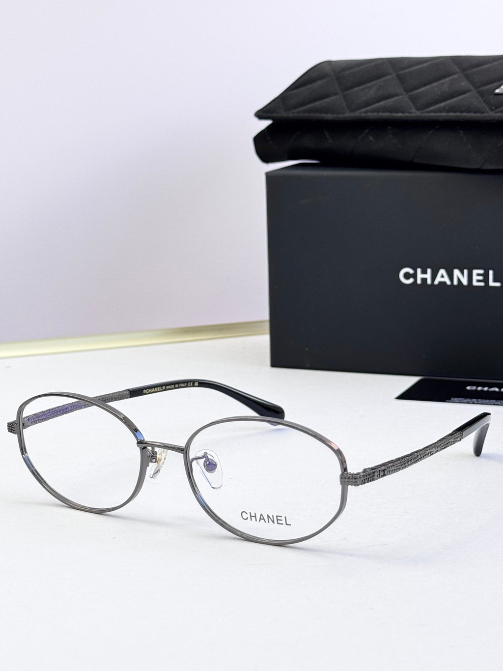 Chanel eyeglasses with dark round frames and clear lenses