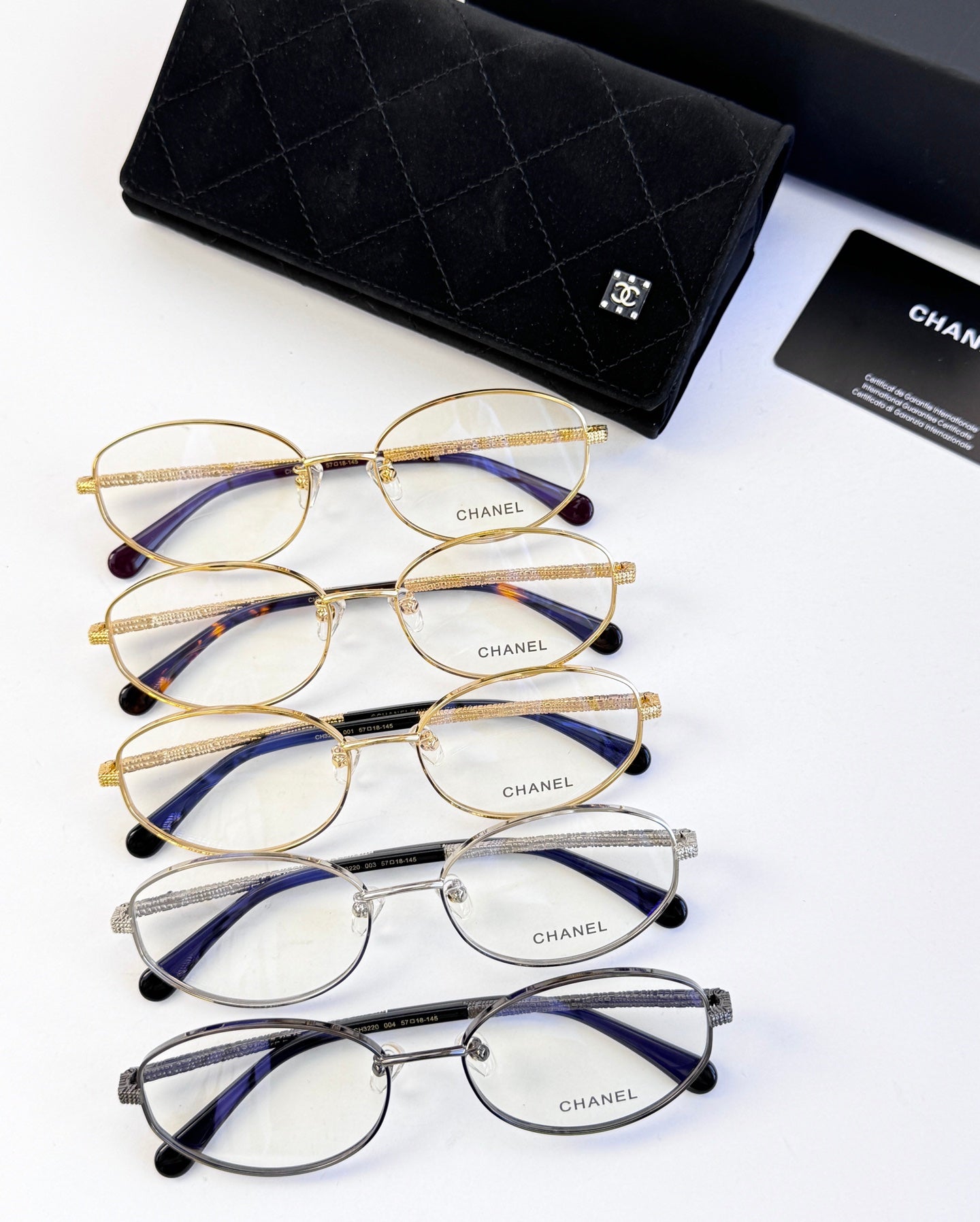 Set of Chanel eyeglasses with gold, blue, and silver round frames
